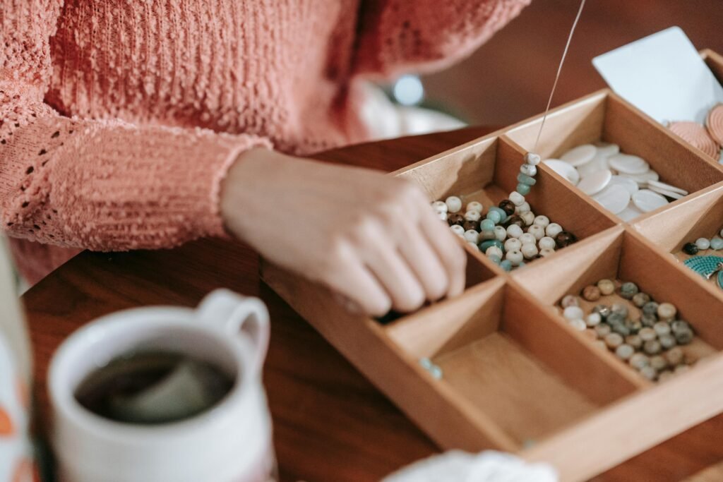 A close-up view of bead crafting with tea, showcasing creativity and leisure.